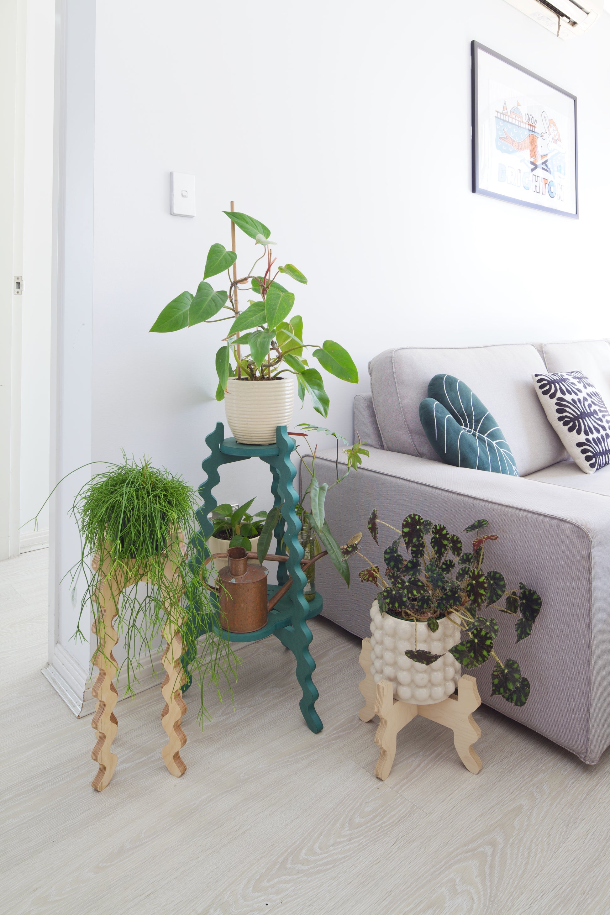 Three Xigglie Plant Stands. Australian designed and made in Birch Plywood and moisture-resistant MDF. Supporting plants in a modern living room.
