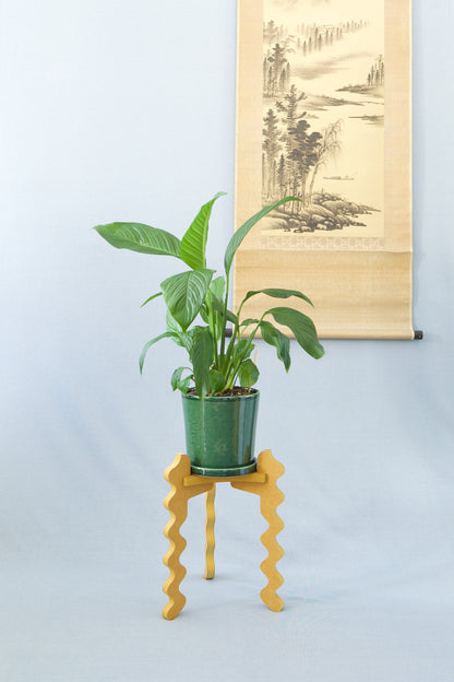 Xigglie Saffron Trio Plant Stand. Australian designed and made in yellow moisture-resistant MDF. Supporting plant & green pot.