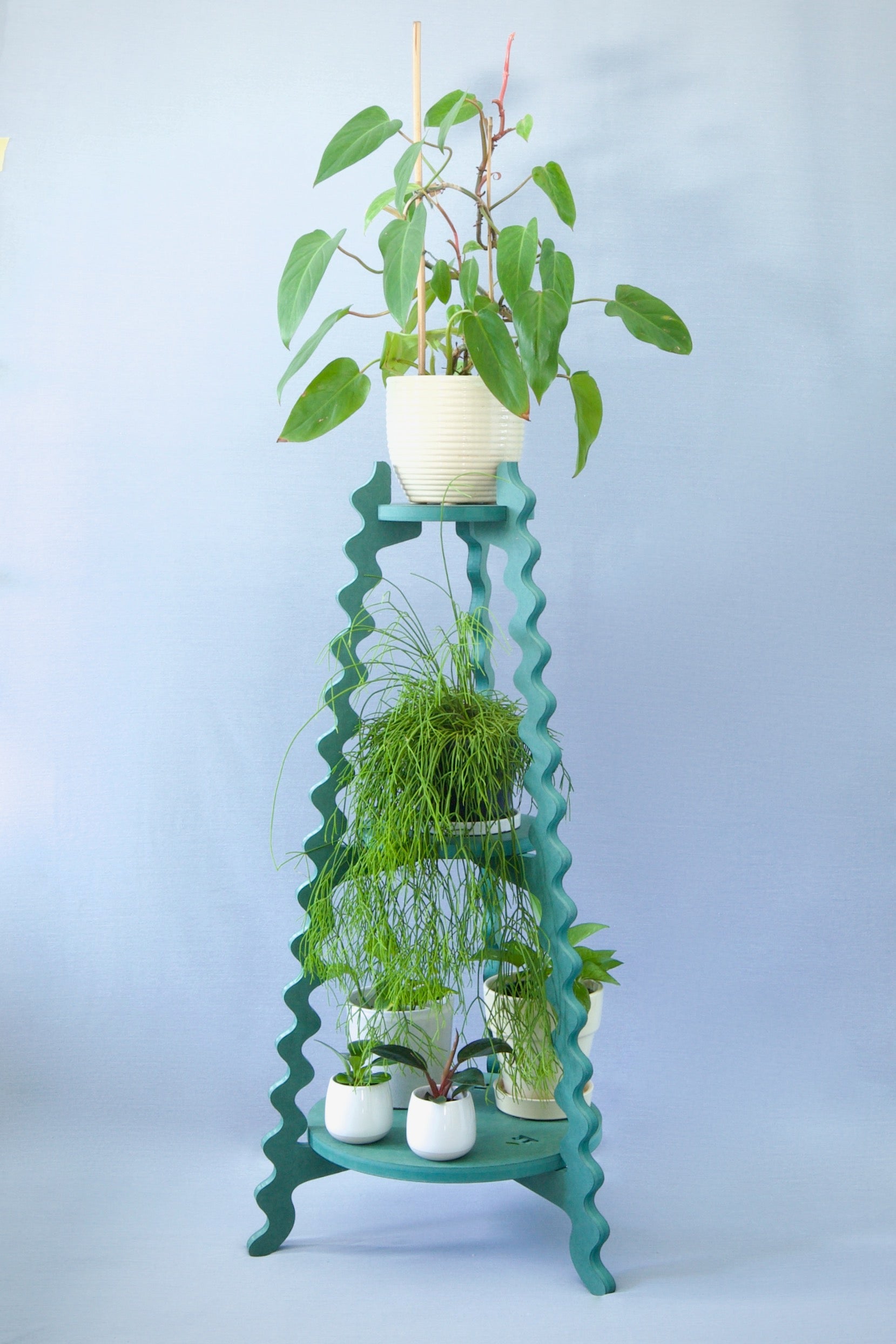 A Xigglie Sage Threezy Plant Stand. Australian designed and made in green moisture-resistant MDF, 3 tiers supporting plants in pots.