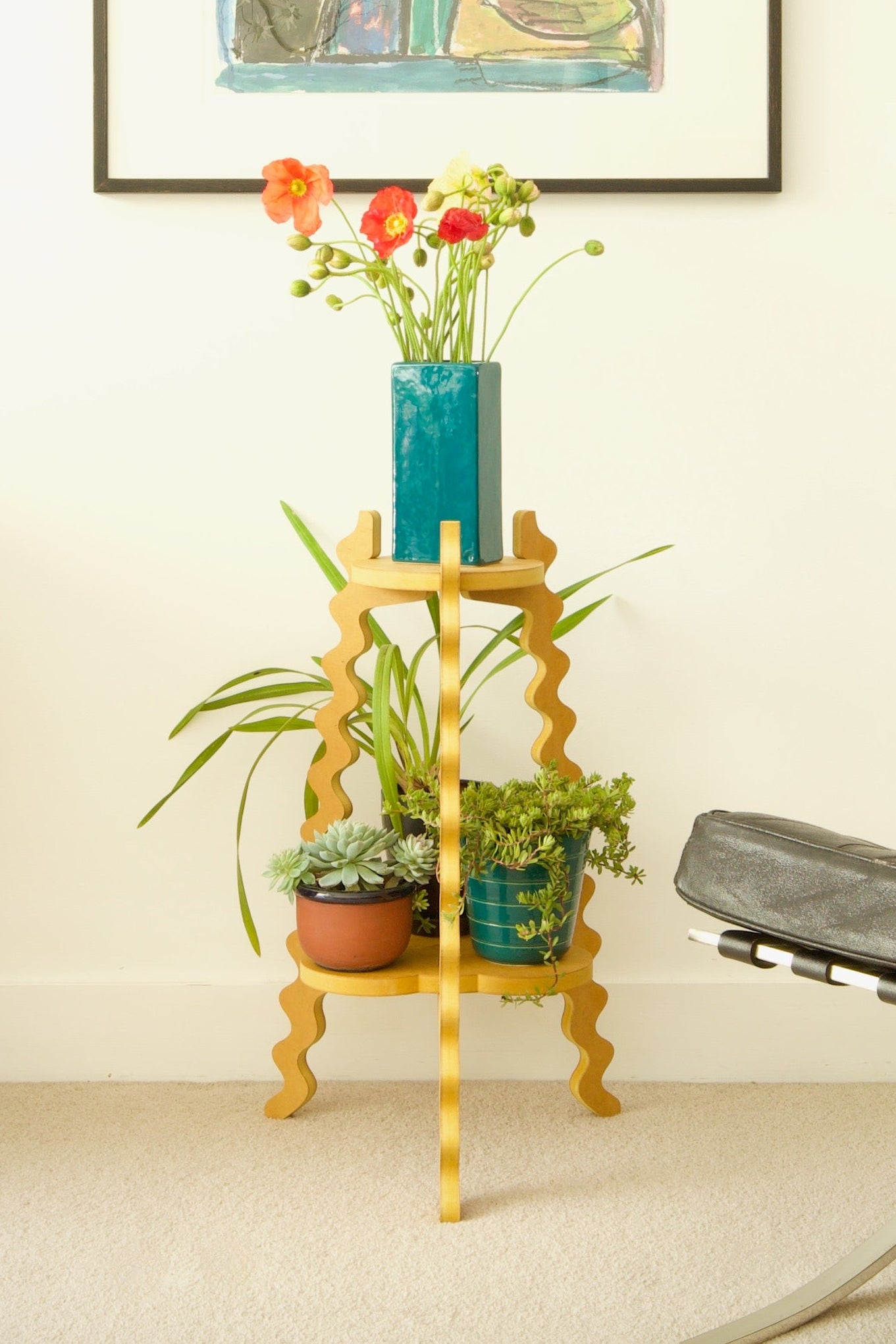 Xigglie Two-Up Plant Stand. Australian designed and made in yellow moisture resistant MDF. Supporting a flower vase and plants in modern living room.