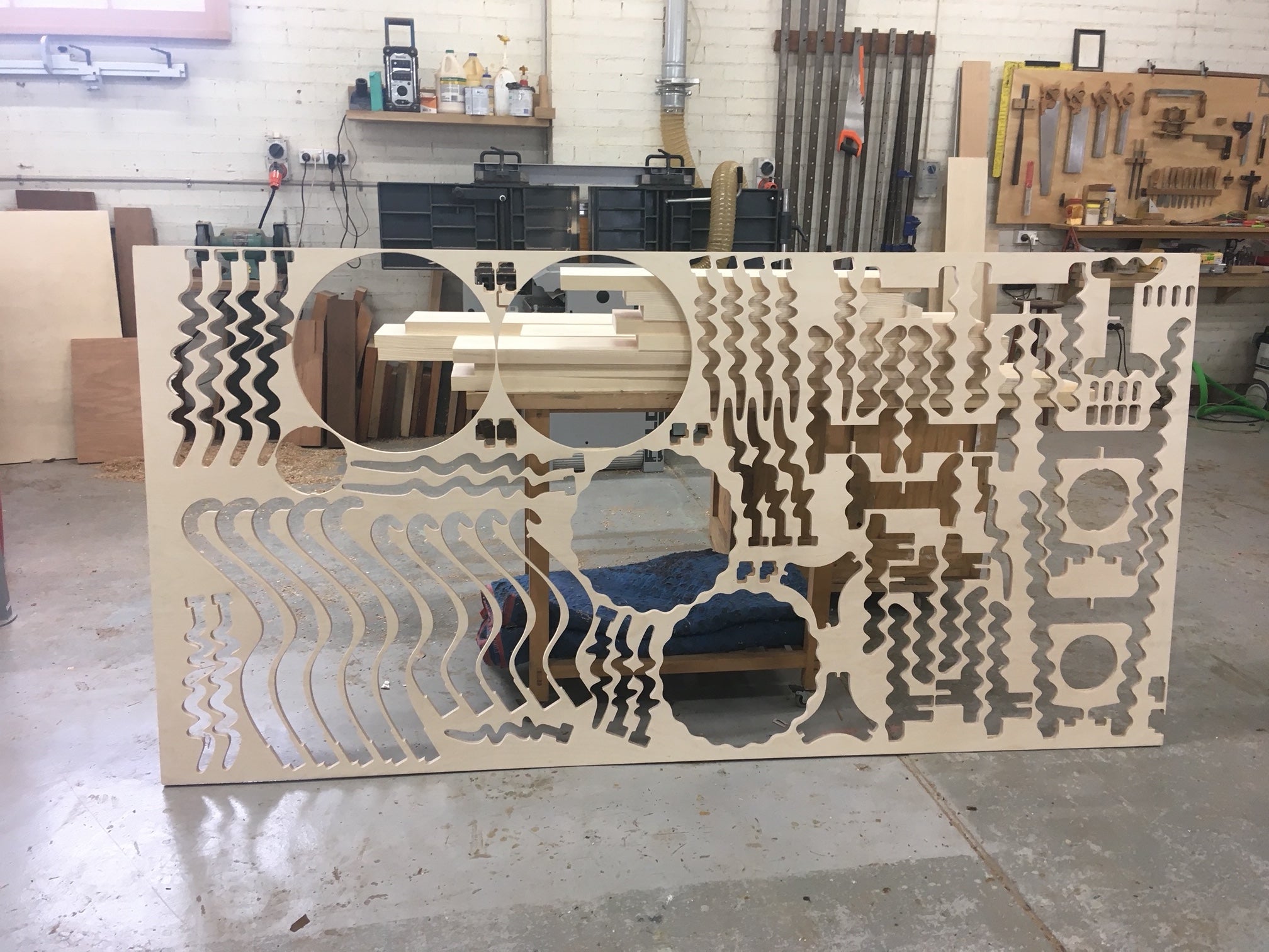 view of plywood sheet after parts have been cut out.